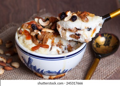 Porridge With Dried Fruit And Nuts In A Spoon