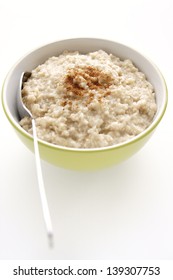 Porridge Or Oatmeal With With A Sprinkle Of Cinnamon Against A Clean White Background