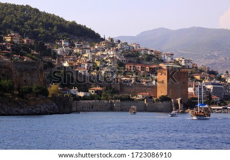 Port of Alanya, Turkey afternoon landscape view with castle and ships sailing on the sea