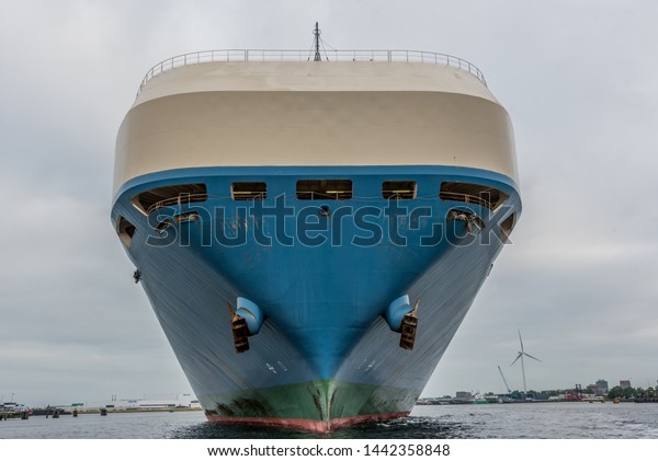 Port of Amsterdam, Noord-Holland/Netherlands -Jun
30-06-19- Ro Ro ship Marguerite Ace is heading to the shore in
port. The vessel is loaded with commercial cars. Cargo ship is
receiving tugboat help.