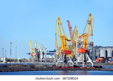 Port cargo crane and container over blue sky background