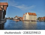  Port crane in the old town of Gdańsk located on the Motława River, a branch of the Vistula River                            