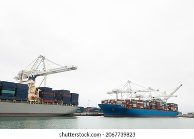 Port cranes offload cargo containers from sea vessels. - Shutterstock ID 2067739823