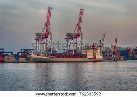 Port cranes and a ship on unloading. Sea transport