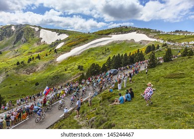 PORT DE PAILLERES,FRANCE- JUL 6:: The peloton climbing the road to Col de Pailheres in Pyrenees Mountains during the stage 8 of the 100 edition of Le Tour de France on  July 6, 2013.