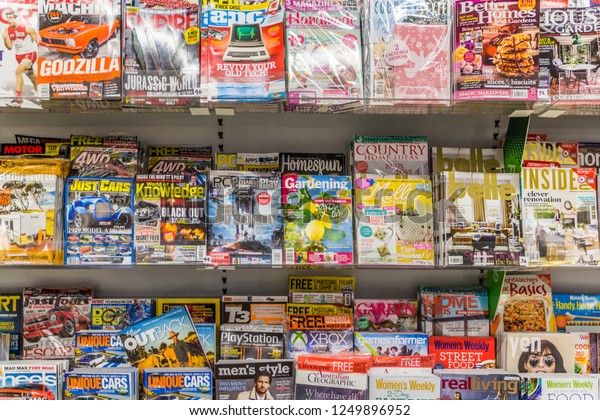 Port Douglas, Australia - 1st June 2015:\
Magazines on shelves for sale in Supermarket. A huge variety of\
subjects are covered.
