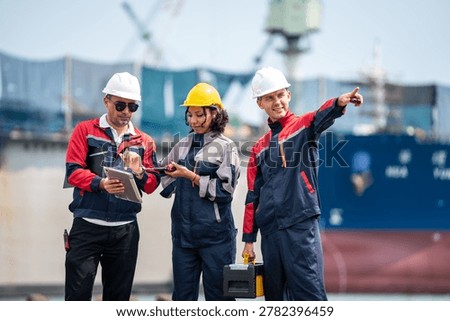 Port engineers coordinating cargo operations during maritime shipping inspection near industrial harbor with commercial freight vessel and logistics activity.