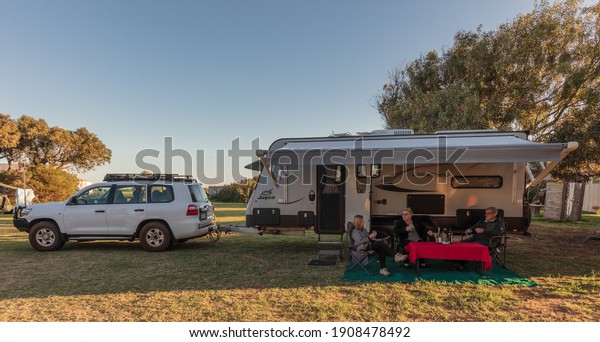 Port Gregory, WA,\
Australia - Aug 26, 2020: Grey Nomads relax outside their caravan\
camped at the \