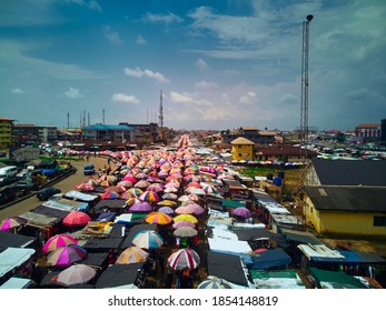 Port Harcourt, Nigeria - November 10, 2020: Mile I Market, A Crowded Marketplace In Port Harcourt City With Structures Consisting Mostly Of Colourful Umbrellas Serving As Shade And Space For Traders.