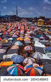 Port Harcourt, Nigeria - November 10, 2020: Mile I Market, A Crowded Marketplace In Port Harcourt City With Structures Consisting Mostly Of Colourful Umbrellas Serving As Shade And Space For Traders.