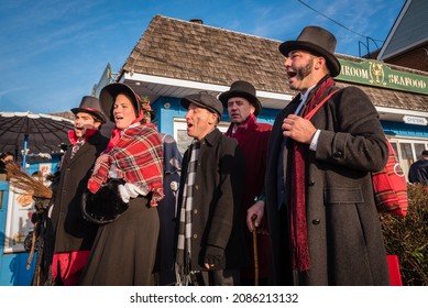 Port Jefferson, New York-November 4, 2021:   25th Annual
Charles Dickens Festival, a group of holiday song singers dressed as Dickens time. 