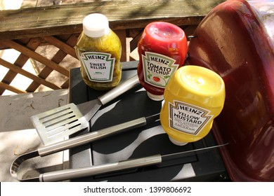 Port Jefferson Station,NY, USA May 15,2019. Condiments On A BBQ With Utensils .BBQ Concept For Summer.