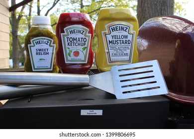 Port Jefferson Station,NY, USA May 15,2019. Condiments On A BBQ With Utensils .BBQ Concept For Summer.