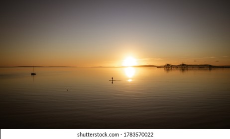 PORT LINCOLN, SOUTH AUSTRALIA, JULY 2020; Sunrise behind grain silos on the jetty on Boston Bay.