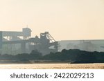 Port loading facility partial silhouette skyline from dust and smoke at Bunbury port.