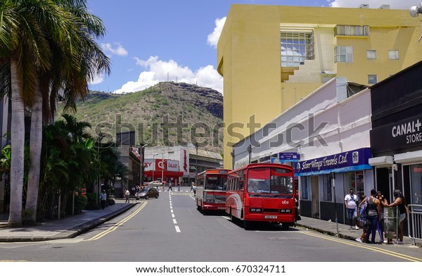 Port Louis, Mauritius -\
Jan 14, 2017. Cars run on street in Port Louis, Mauritius. Port\
Louis is the country economic, cultural, political centre and most\
populous city.