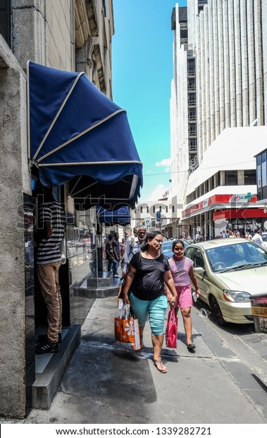 Port Louis, Mauritius - Jan 4, 2017.\
People walking on street of Port Louis, Mauritius. Port Louis is\
the country economic, cultural and political\
centre.