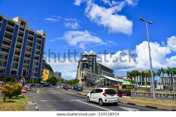 Port Louis, Mauritius - Jan 4, 2017. Cars on\
street in Port Louis, Mauritius. Port Louis is the business and\
administrative capital of the\
island.