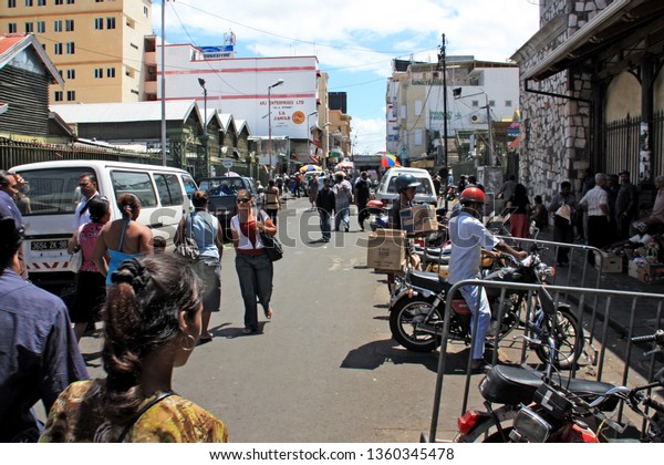 Port Louis,\
Mauritius - November 12th 2009: The commercial heart of Port Louis,\
where the old market is located left and right of this street in\
the huts visible on the\
left
