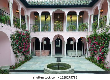 Port Lympne Mansion Hotel, Kent, UK, 2019. Moroccan Themed Courtyard With A Small Fountain And Arched Balconies.  The Hotel Is Owned By The Aspinall Family And Is A Popular Wedding Venue.