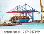 Port in Malaga, container terminal. Container cargo freight ship in port. Spain