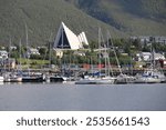 Port of the Norwegian city of Tromso with the Arctic Cathedral in the background  