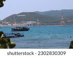 The port and old boat in Hon Soi Island in Vietnam with blue sea water and the jetty. 