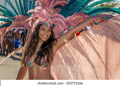 PORT OF SPAIN, TRINIDAD - February 17: A Female Masquerader enjoys herself in the Harts Carnival presentation-Dominion of the sun-, February 17, 2015 on the streets of Port of Spain, Trinidad.