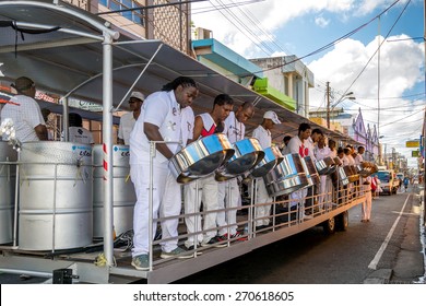 PORT OF SPAIN, TRINIDAD - February 17: Exodus steel orchestra band members perform in down town Port of Spain on carnival Tuesday, February 17, 2015 on the streets of Port of Spain, Trinidad.