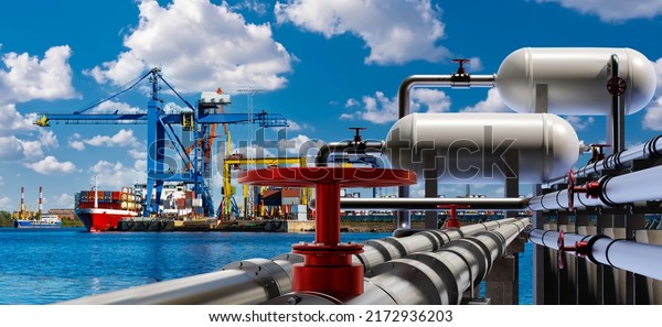 Port terminal. Berth for unloading liquefied gas. Supply\
of liquefied gas across ocean. Terminal for loading gas onto ships.\
LNG equipment near sea. Port crane unloading ship in background.\
