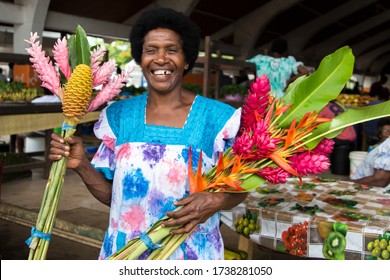 PORT VILA, VANUATU - MAY 22, 2020: Portrait of one Woman from Vanuatu, holding exotic colorful flowers