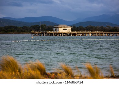 PORT WELSHPOOL, VICTORIA, AUSTRALIA - 06 APRIL 2018: The Ruins Of The Old Long Jetty In Corner Inlet With The Distant Peaks Of Wilsons Promontory National Park In The Background.