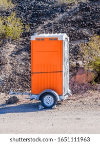 Porta Potty At A Contruction Site Along The Road.  Porta Potty On Mobile Trailer.