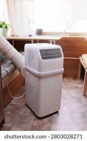 Portable air conditioner unit operating inside a modern camper van during a summer heatwave