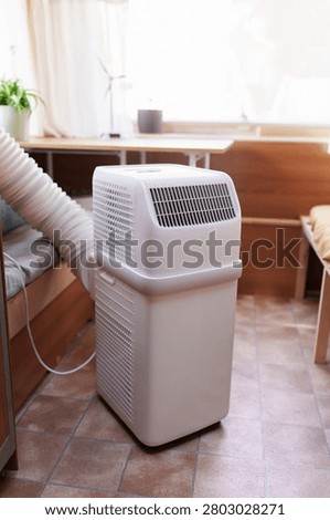 Portable air conditioner unit operating inside a modern camper van during a summer heatwave