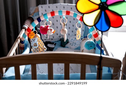 Portable baby crib. Toys above the baby's crib. Hanging cute little toy teddy bears for the child - Powered by Shutterstock