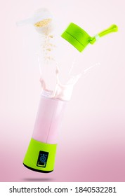 

Portable Blender With Vitamin Splash On Pink Background