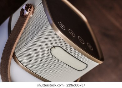 portable bluetooth speaker for listening music. White and gold wireless loudspeaker