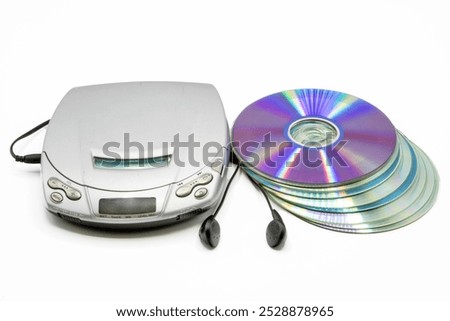 Portable CD player with a stack of cd's next to it isolated on white background
