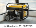 Portable electric generator running in the cold winter.Energy genocide. Small business use gasoline generators