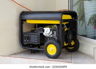 Portable electric generator running in the cold winter.Energy genocide. Power outage as a result of missile strikes by Russia on energy facilities of Ukraine. Small business use gasoline generators - Shutterstock ID 2234103499