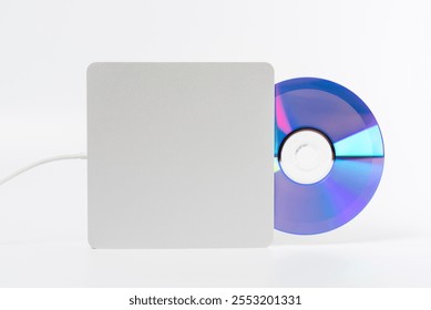 Portable external DVD, CD Drive with DVD disc isolated over white background. Optical drive for player and burner disc for computer.
