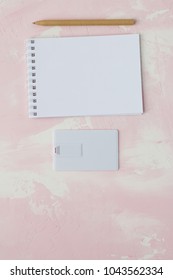 Portable Flash Drive Card Or Bussines Card, Notebook, Pen, On Pink Background.mock Up