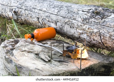 portable gas burner on the wooden logs. camping equipment