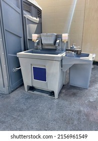 A Portable Hand Washing Station With Soap And Paper Towel Dispenser.