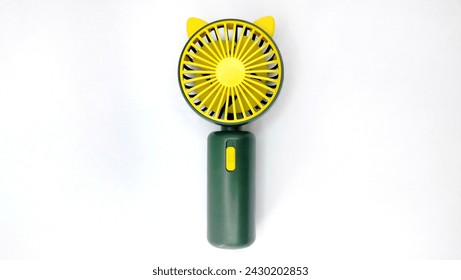 Portable mini fan with handle, Used to increase comfort in various situations, both indoors and outdoors in hot weather. Isolated on white background