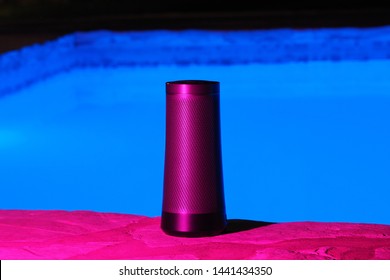 Portable Modern Speaker With Voice Assistant At Night Near The Swimming Pool Neon Light.