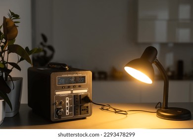 Portable power station charging tablet computer on table in living room - Shutterstock ID 2293478299