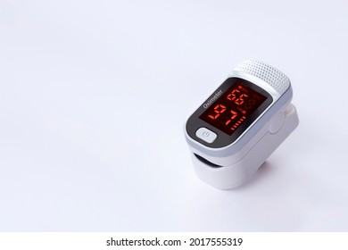 Portable pulse oximeter device on white background, Measurement of blood oxygen level and pulse.