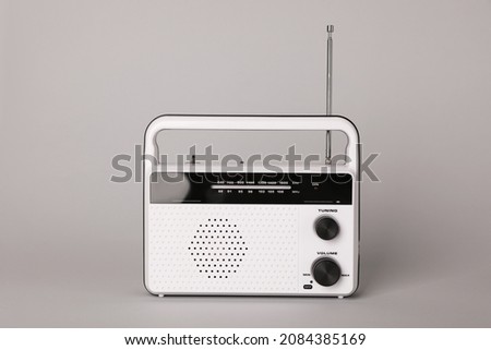 Portable retro radio receiver on grey background